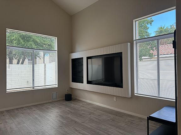 Double height, vaulted ceilings let in natural light. Small dog door perfect for dogs under 10 to 15 pounds. The 65" TV and soundbar with subwoofer come with property if desired.