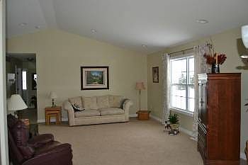 The great room is in the center of the home.  Perfect for relaxing or gathering with family and friends.  The large window looks out into the backyard and the vaulted ceilings make the room feel huge. 