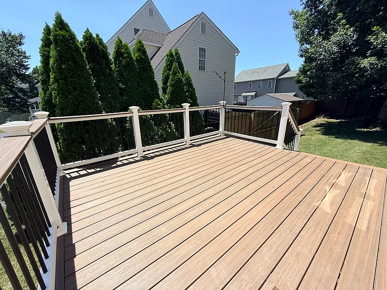 Expansive rear deck with Trex decking and elegant custom balusters