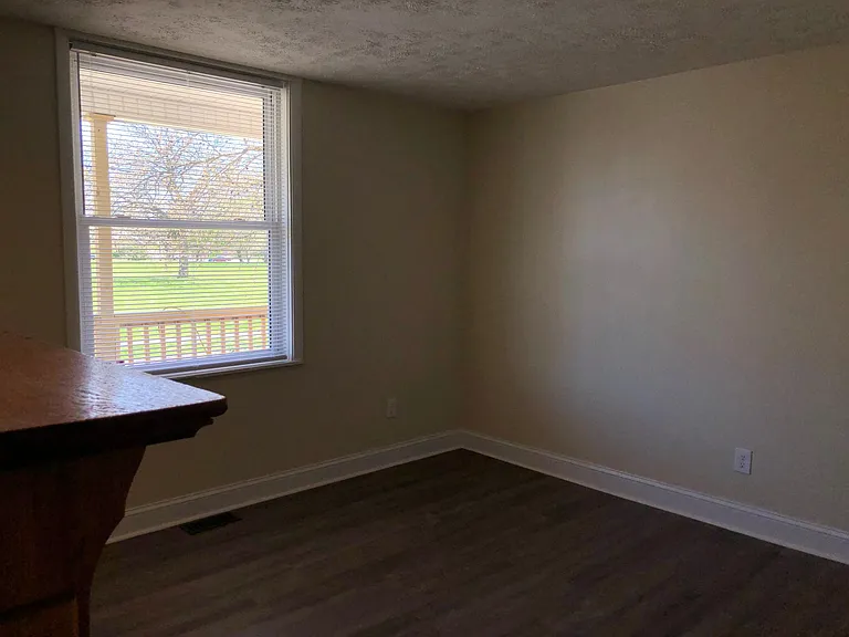 Front den with view of deck and park