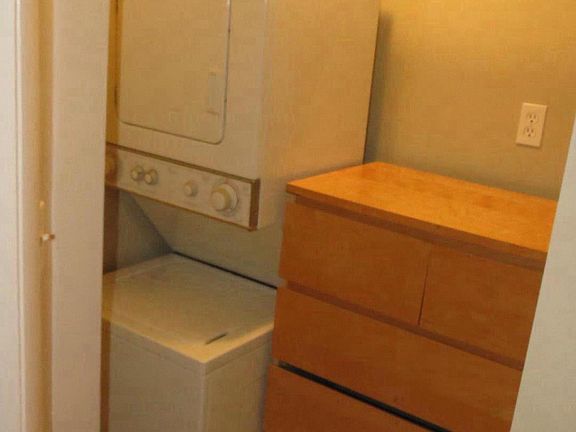 Walk in closet with dryer.