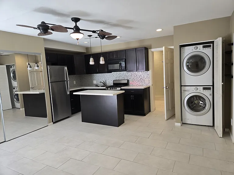 This Image shows the Kitchen, Washer & Dryer and the Closet are with sliding Mirrored Doors