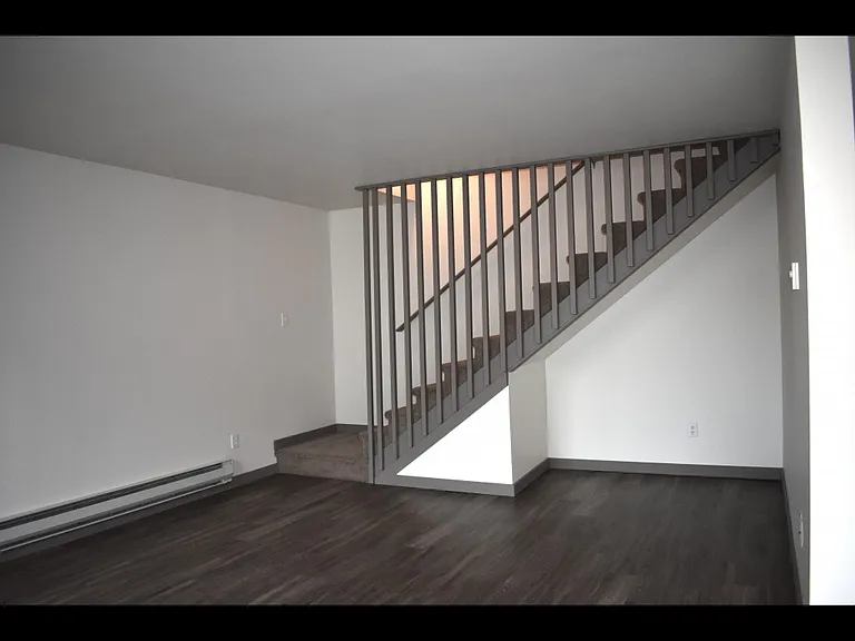 Town home stairs leading upstairs to two spacious bedrooms, full bathroom, full size washer and dryer room and more.