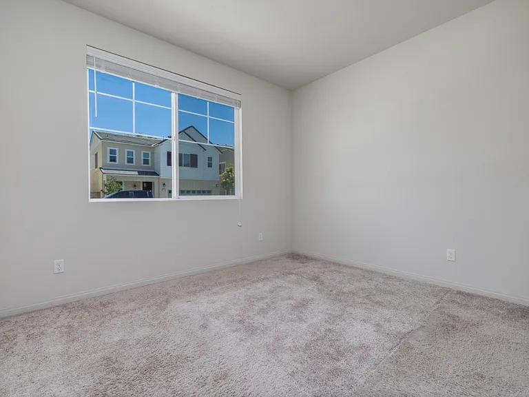 Another angle of the upstairs bedroom showcasing how abundant natural light fills the space through the large window. The bright and airy design enhances comfort, making it a perfect spot for relaxation or study.