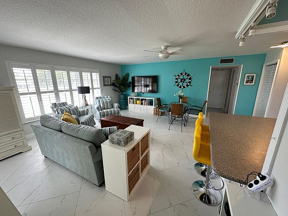 Tropical themed living area with 65" TV