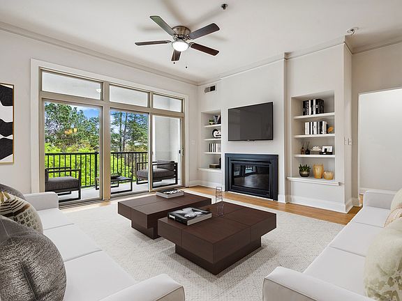 Living room with wood flooring and patio access
