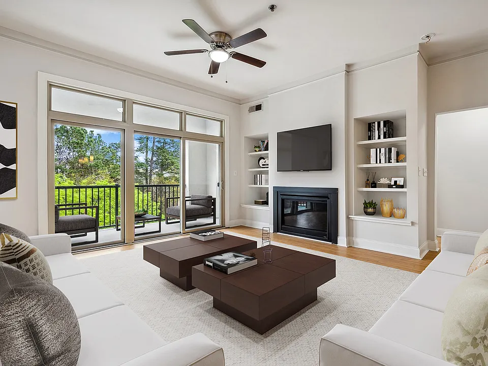 Living room with wood flooring and patio access