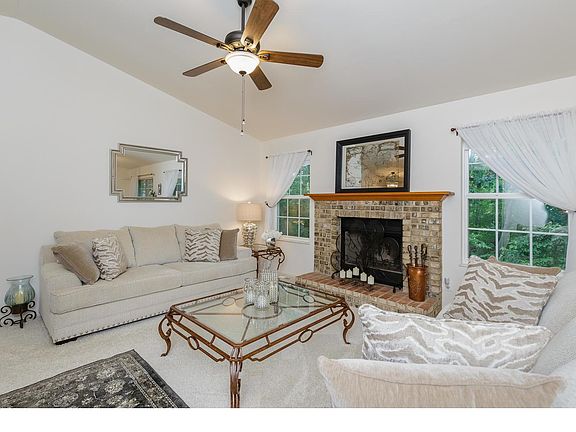 Great Room with Vaulted Ceilings and Wood Burning Fireplace
