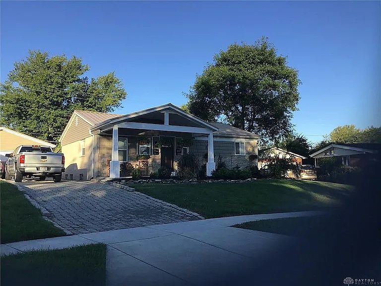 Front view shows the expansive front porch