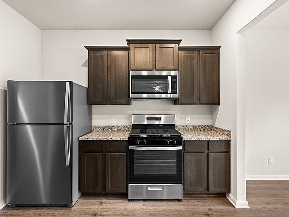 The kitchen of the Rayburn has gorgeous wood cabinetry.