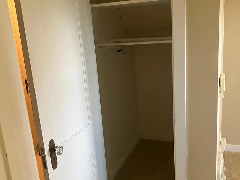 Closet in hall between living room and bathroom.