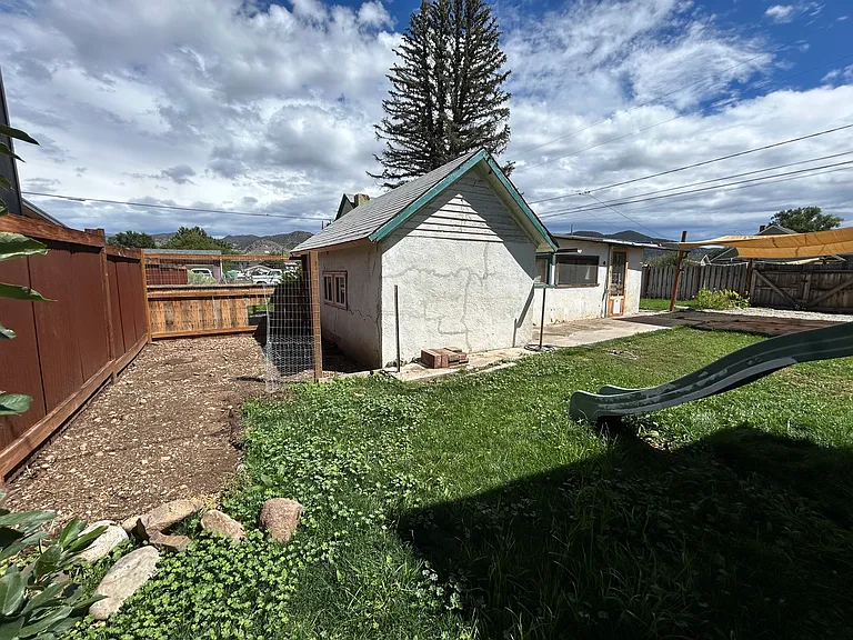 Behind the house: former home of a distinguished chicken coop. The hens have moved out, but the space is ready for your next flock_or whatever quirky backyard dreams you've got clucking around in your head.