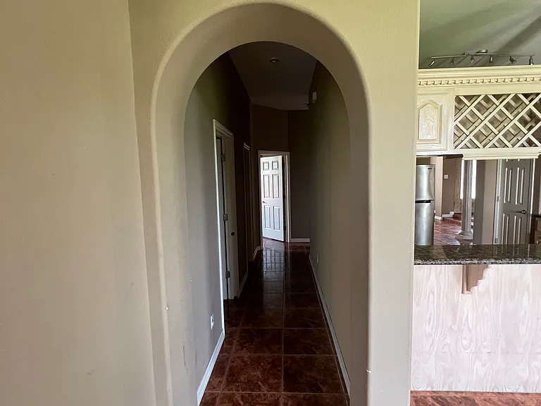 Two bedrooms and a full bathroom are conveniently located off this hallway