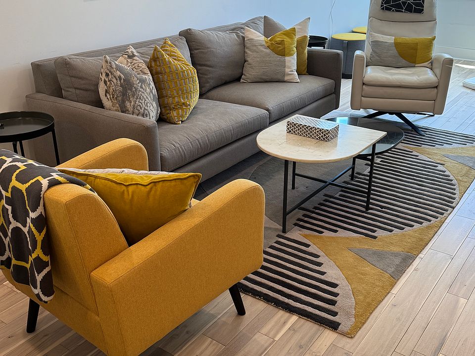 Living room with reclining leather chair faces large screen TV