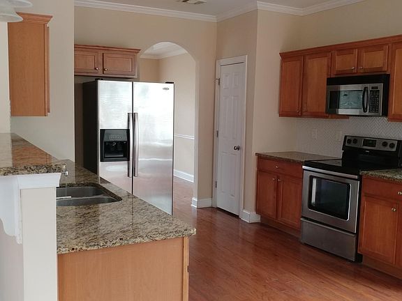 Spacious eat in kitchen with solid surface countertops.