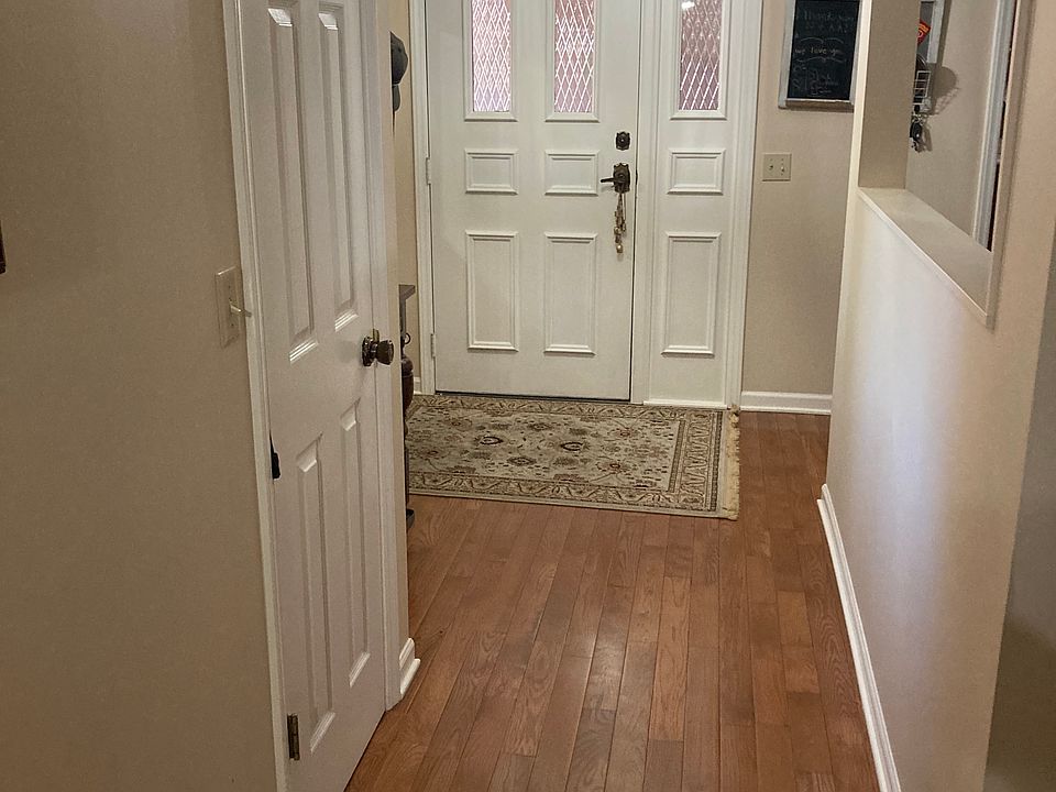 Entrance door and corridor with hardwood floors