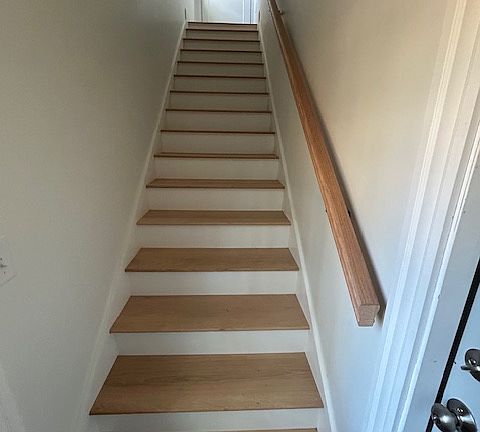 Side entrance stairwell to the apartment. Garage entrance at the bottom of the stairs