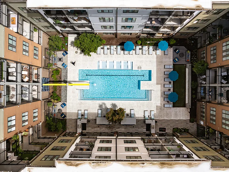 Luxury Apartment Community with Central Pool, Sundeck, and Lounge Seating