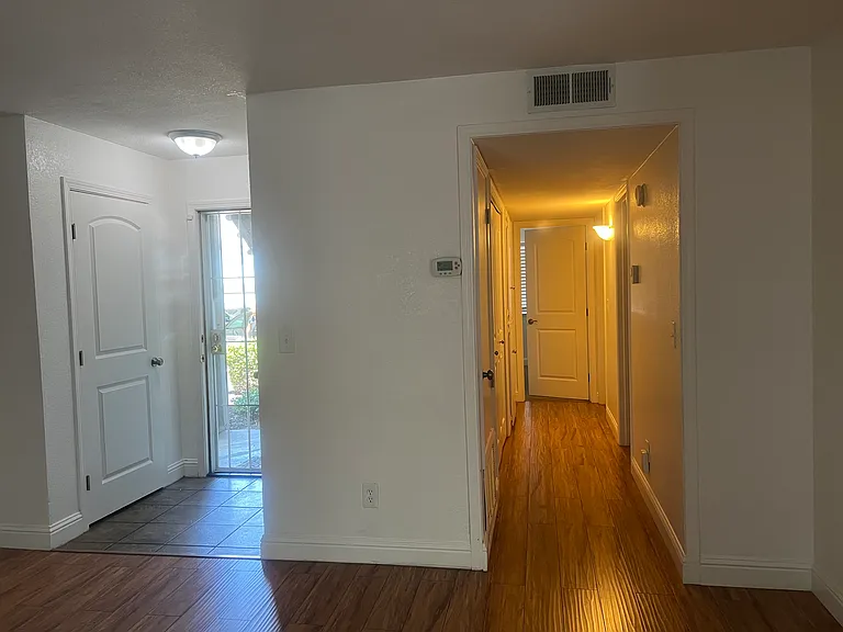 Front door entrance and hallway to bedrooms, second bathroom, laundry closet and linen closet.