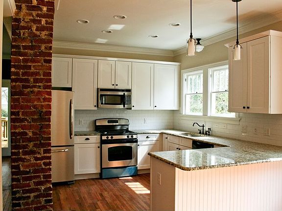 Kitchen - features stainless appliances, shaker style cabinets and granite top