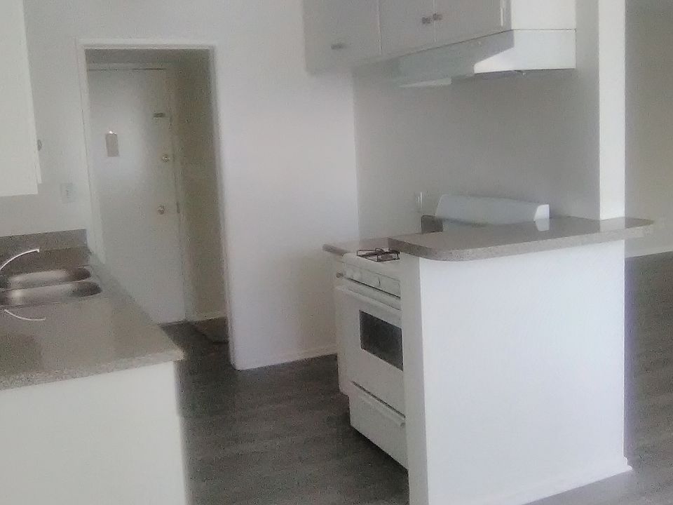 view from dining area theough kitchen to front door