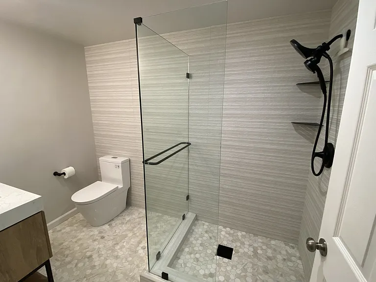 New bathroom with natural stone and porcelain creates a serene, spa-like atmosphere
