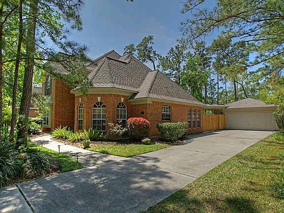 Mature landscaping and a 2-car detached garage.