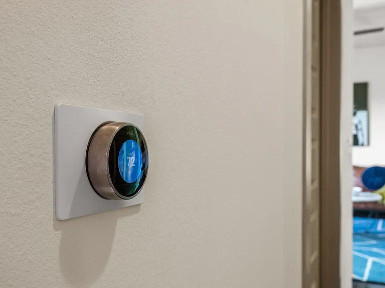 Eco-Friendly Smart Thermostat Installed in Apartment Hallway