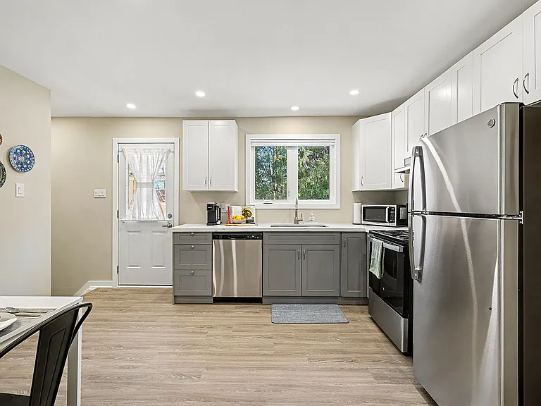 Bright, functional kitchen featuring a dishwasher and window view in our Ottawa temporary residence.
