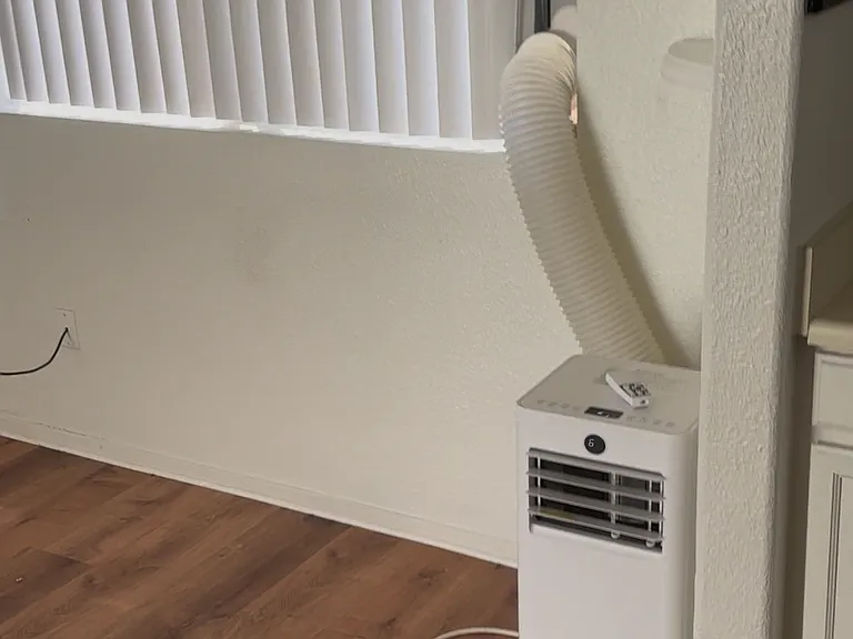 Dining room with separate portable AC unit.