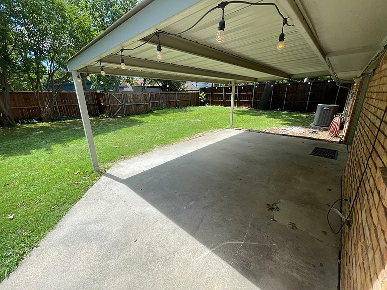 Take a break from the heat under the covered patio and enjoy your large backyard!