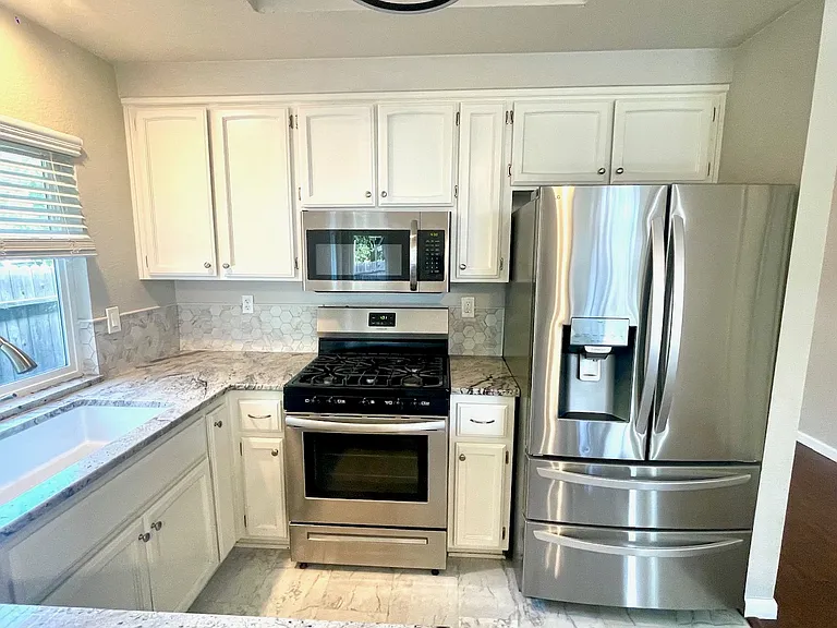 kitchen upgraded with countertop and stainless steel appliances