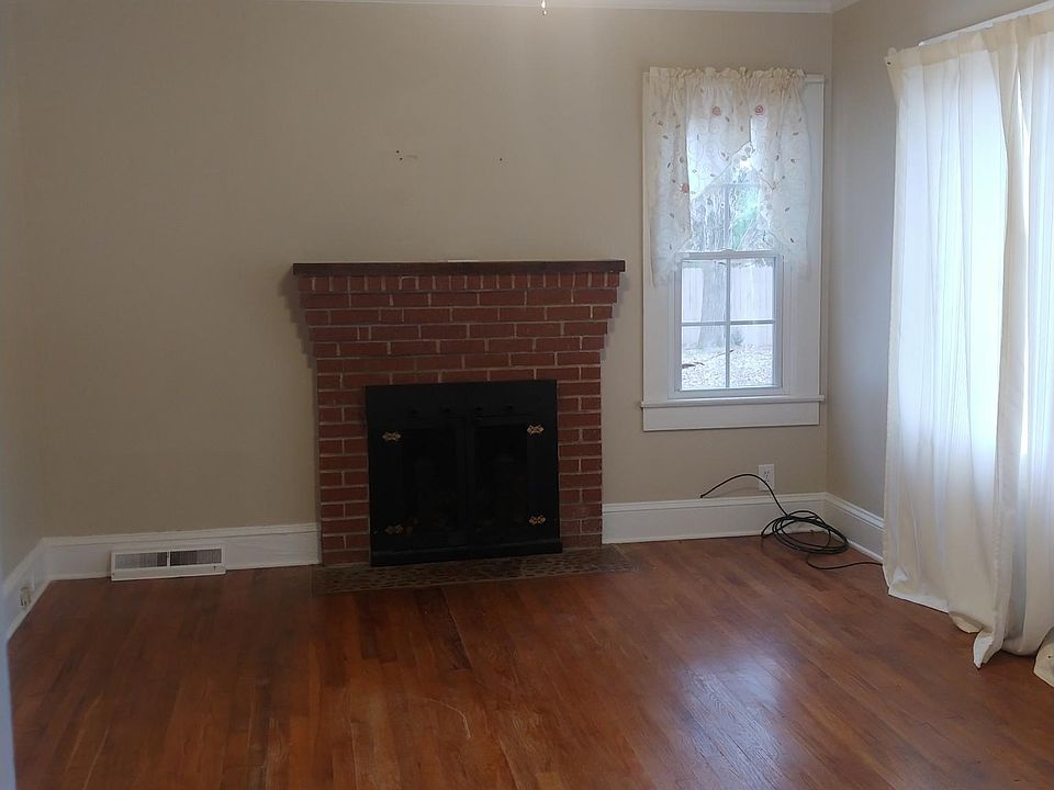 Living room working fireplace. Front door access to porch.