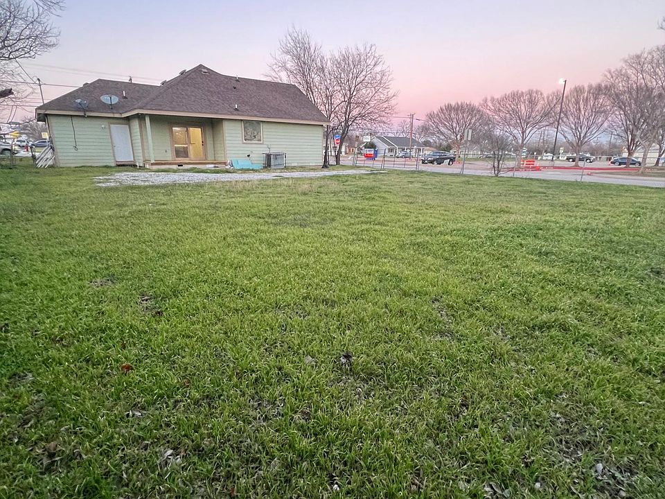 Back yard with driveway gravel to add extra parking in the back if desired.