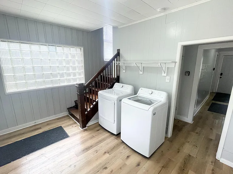 Convenient laundry area with in-home washer and dryer, durable flooring, and nearby access to main living spaces.