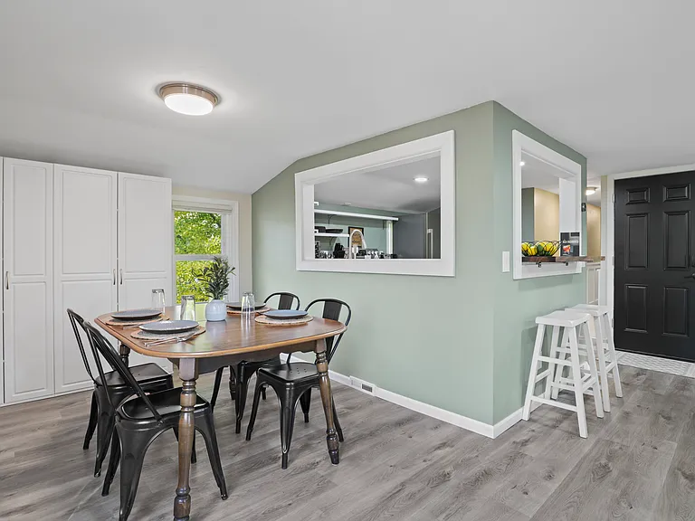 Dining room with 4 spots, and ample storage with floor to ceiling storage shelves.