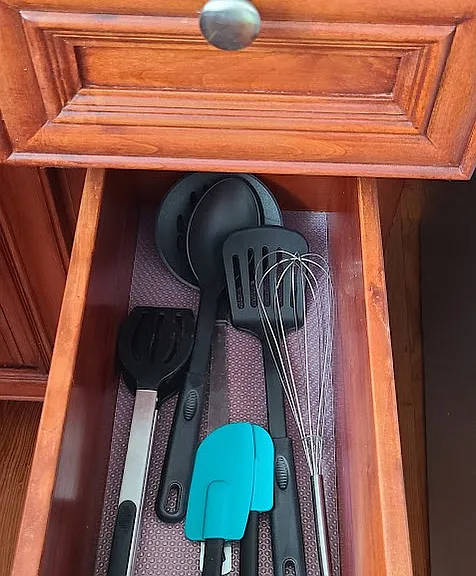 Kitchen dish towels and cooking utensils.