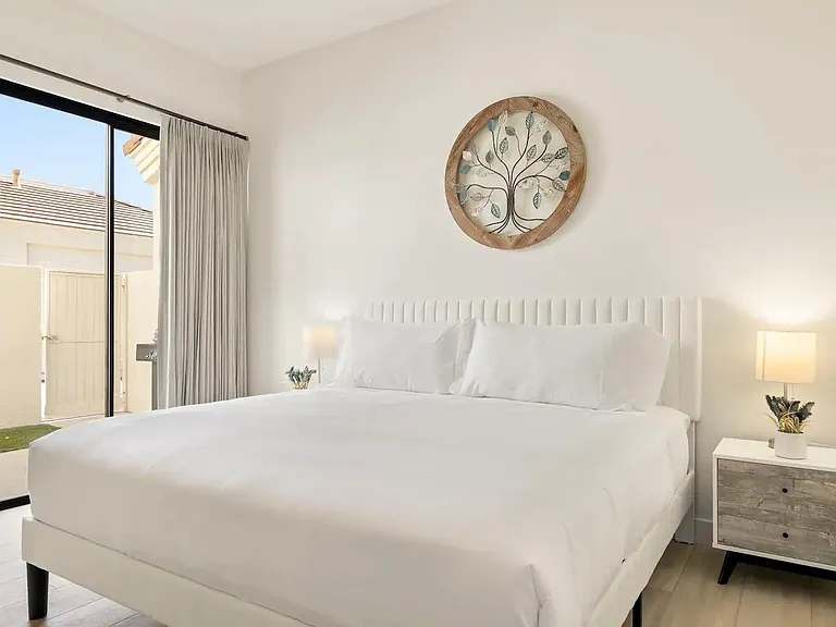King bed in primary with private patio and ensuite bathroom. Includes 52" smart TV