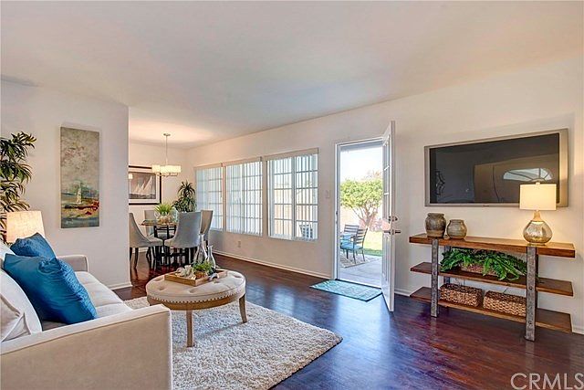 Bright living room with dual pane windows. Newly refinished hardwood floors.