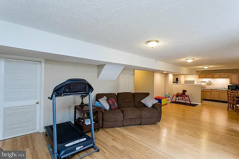 Basement Family Room or Rec Room, there is a 2nd Laundry Room + Storage in the area behind the white doors.