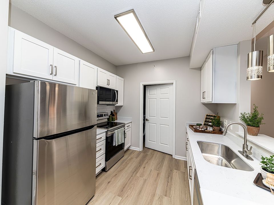 Kitchen with quartz counters, modern cabinetry, & stainless appliances