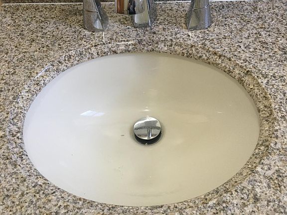 BATHROOM WITH GRANITE COUNTERTOP AND KOHLER FAUCET