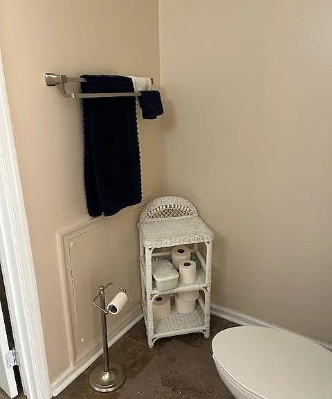 Large bathroom with door between shower and 1st sink area