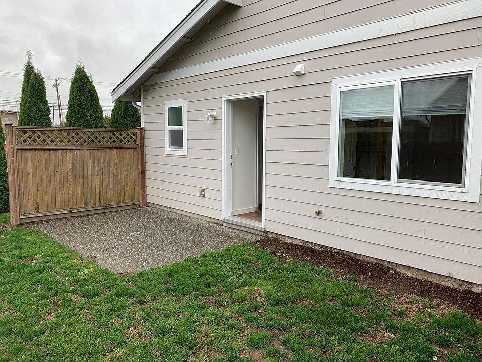 Back door opens onto small patio. Yard is not fully fenced. Double windows are the downstairs bedroom. Single window is the downstairs bath.