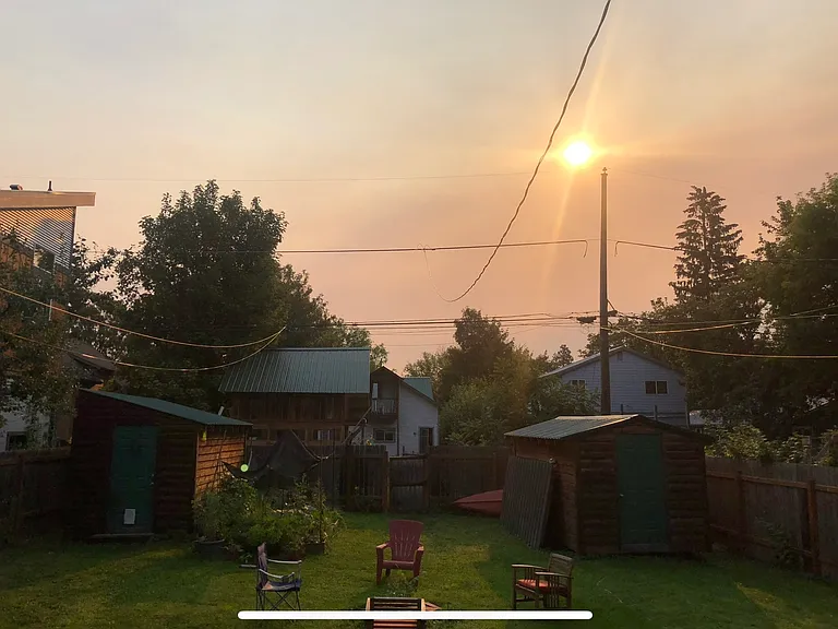 Spacious backyard with storage shed and lots of grass