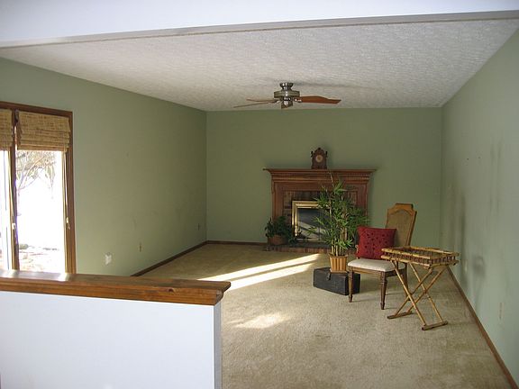 The family room features a fireplace an open floor plan.