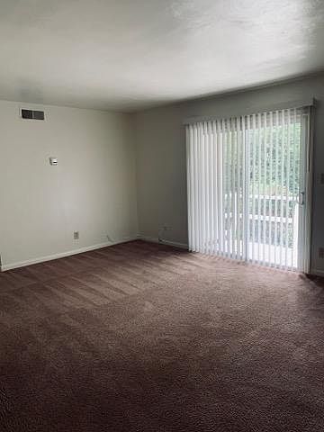 Living room with patio door leading to balcony.