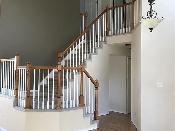 Main staircase leading up to the Primary bedroom and 2 additional bedrooms.