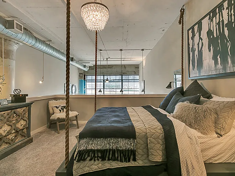Large bedroom with carpet. Loft style