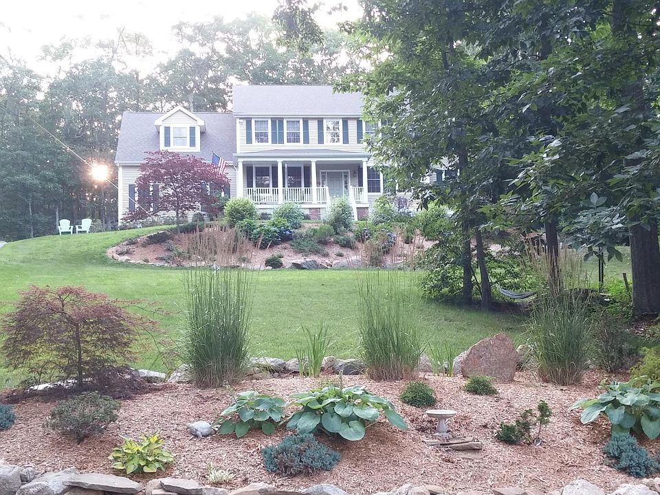Nestled among oaks, maples, dogwoods...this farmhouse colonial welcomes you home.